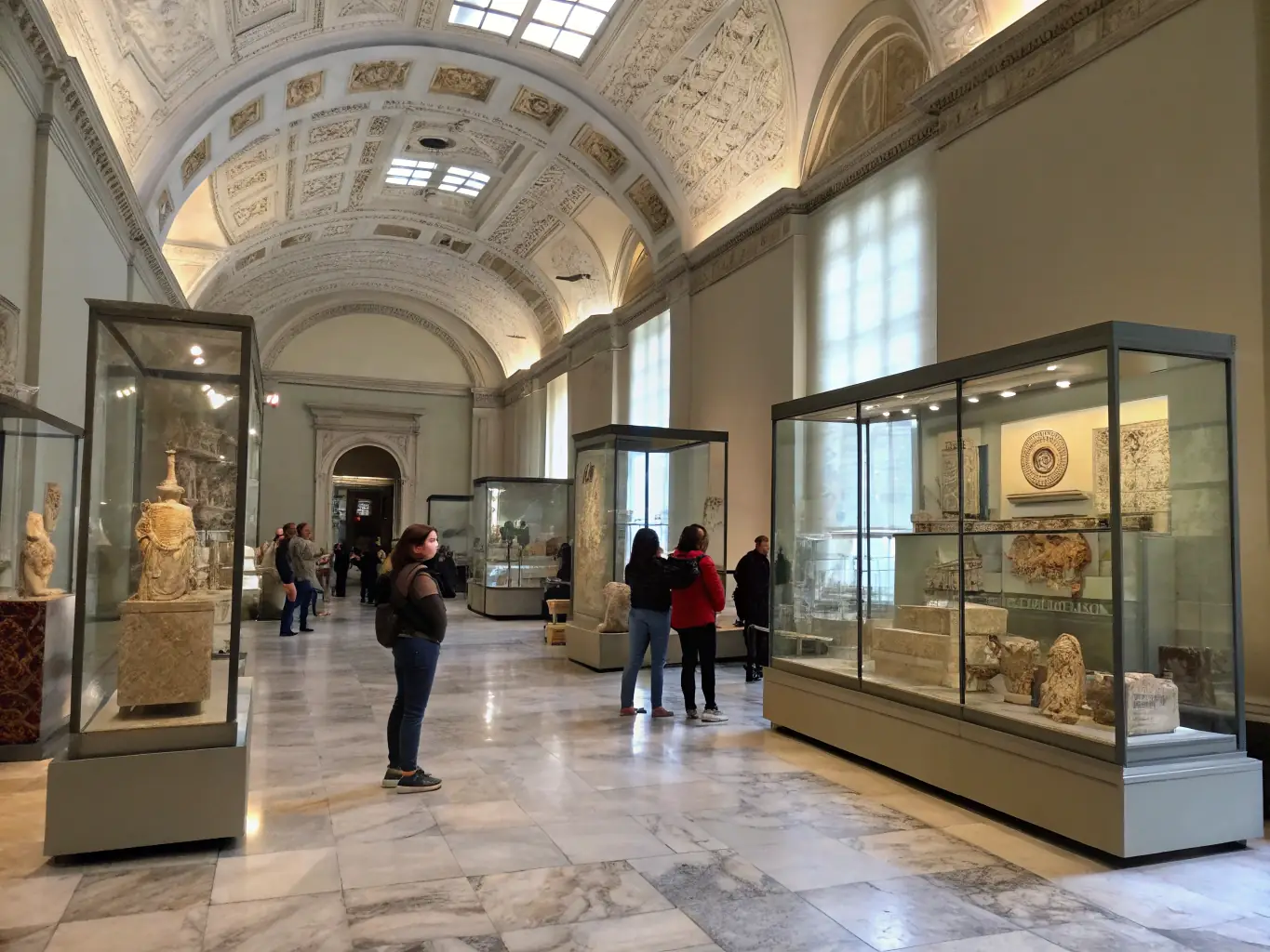 A photograph depicting an exhibition hall filled with historical artifacts and informative displays about the French Resistance during World War II. The scene is well-lit, with visitors carefully observing the exhibits.
